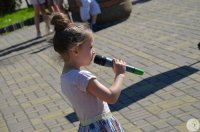 Dziewczynka śpiewa do mikrofonu.